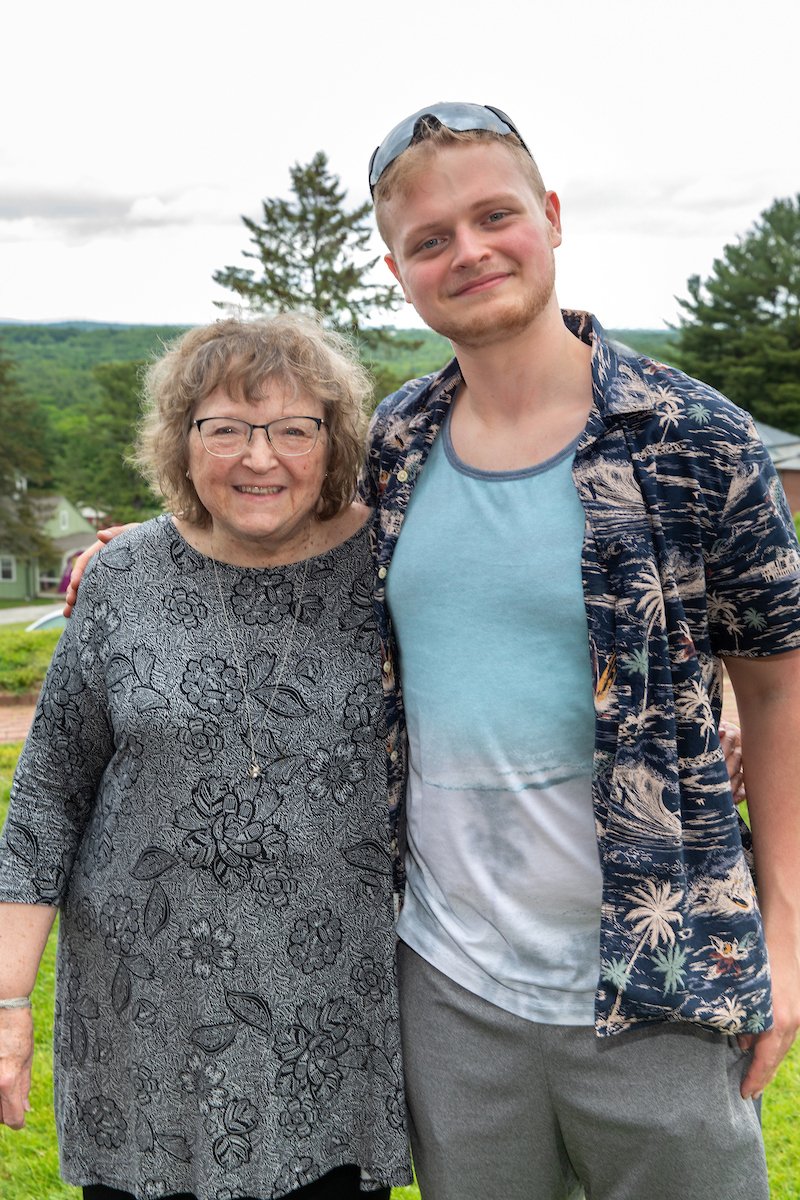 student standing with teacher and smiling at graduation